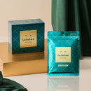 Lululun Precious packaging on a reflective surface with a beige and green background
